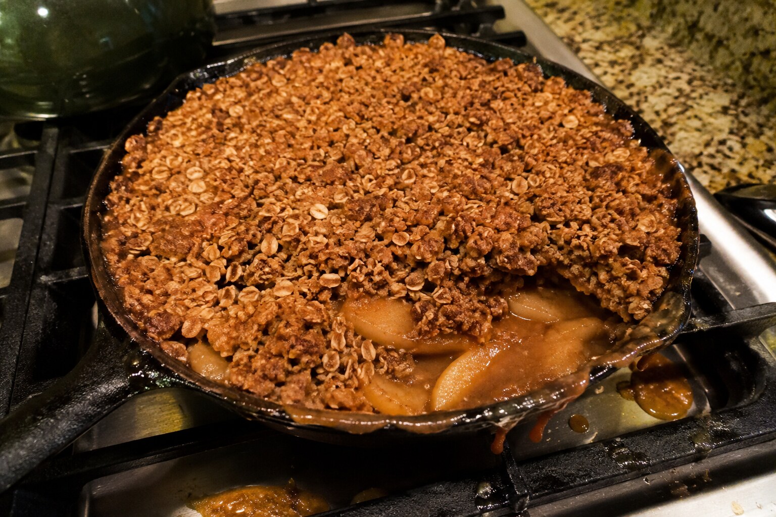 Apple crisp with crumble slid aside and juices bubbled over