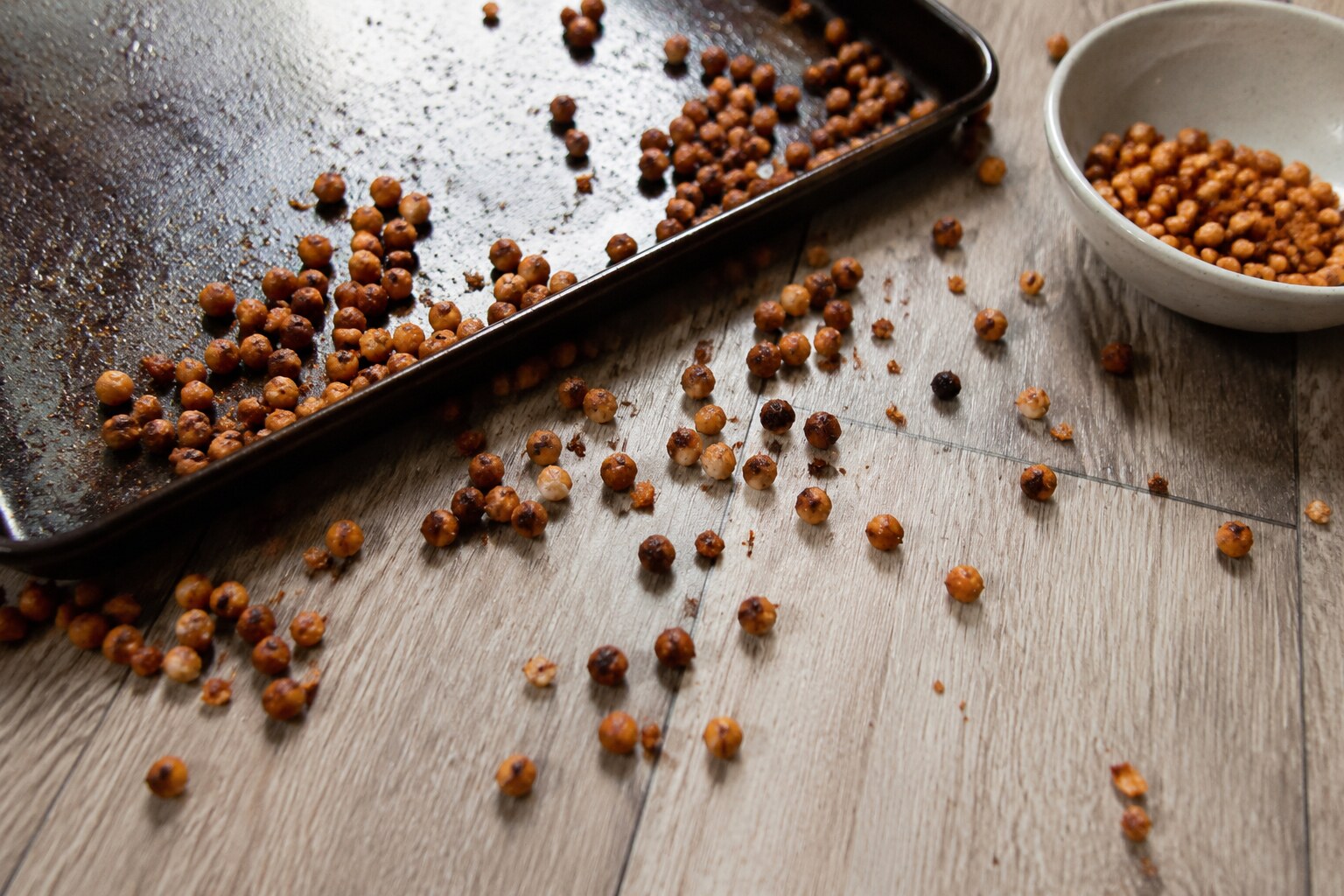 Roasted chickpeas spilled across a baking sheet