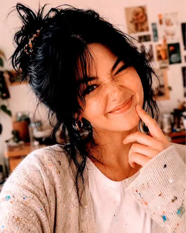 A playful close selfie in a soft cardigan
