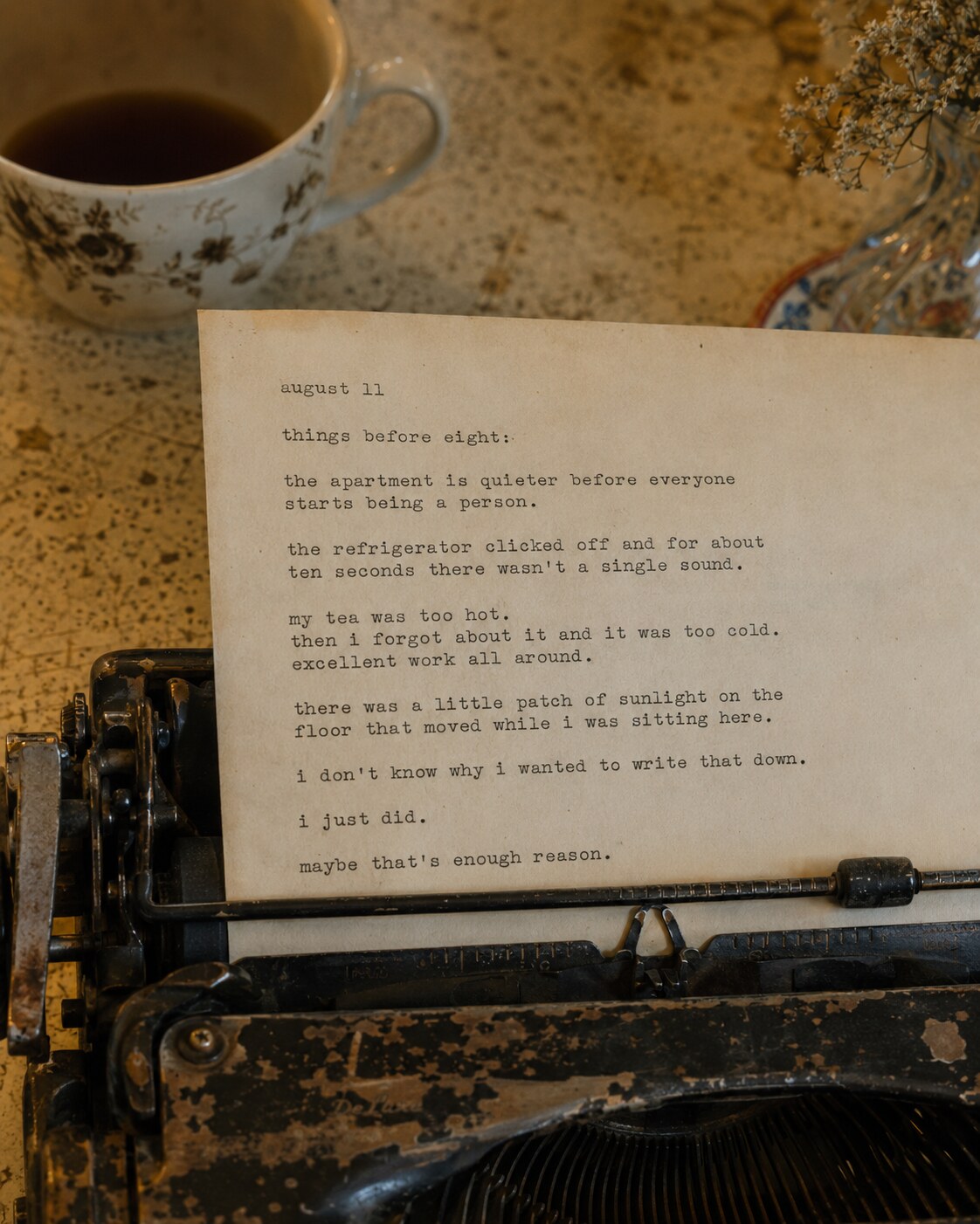 A typed musing on a vintage typewriter beside a cup of coffee