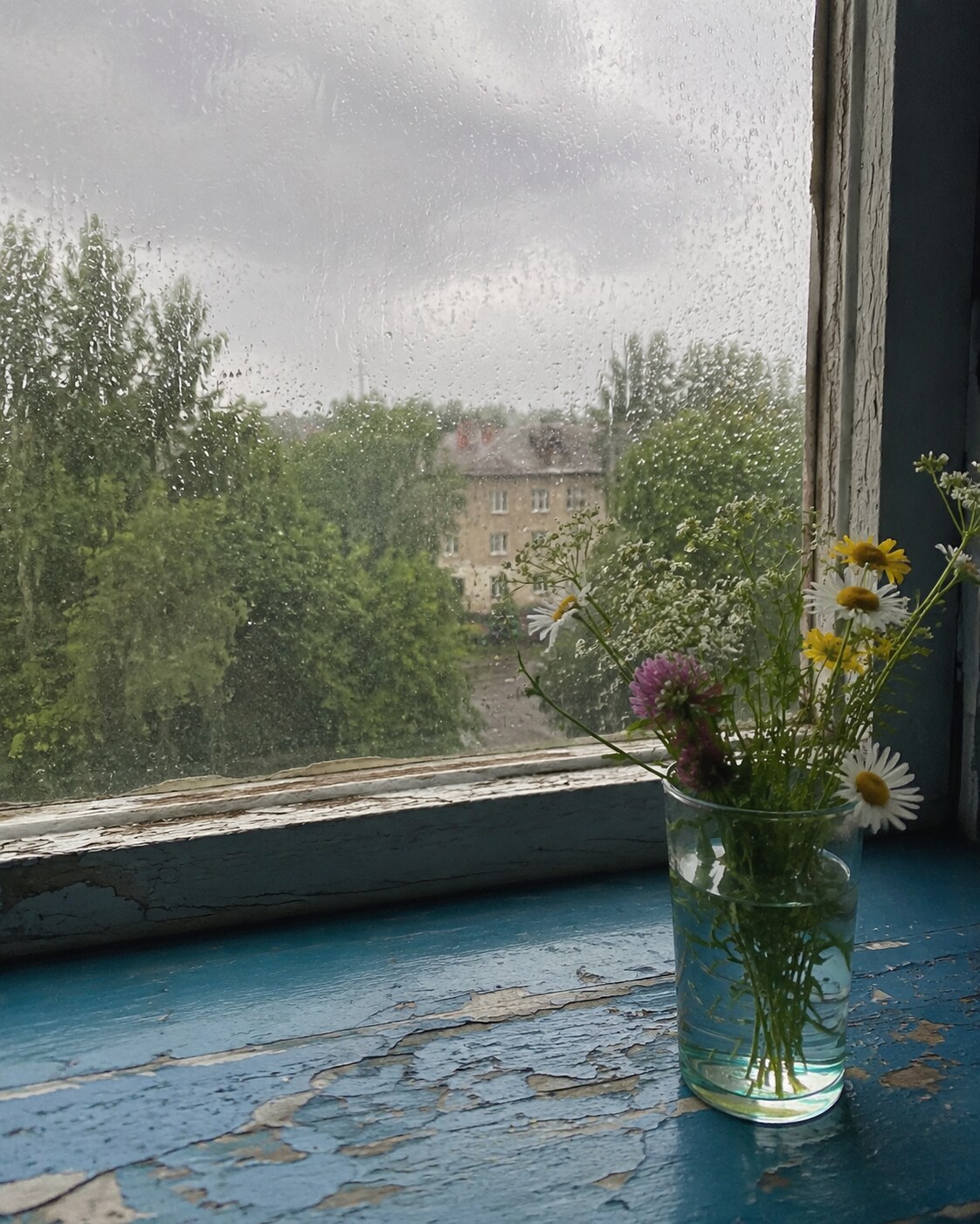 Rain on a chipped blue window sill
