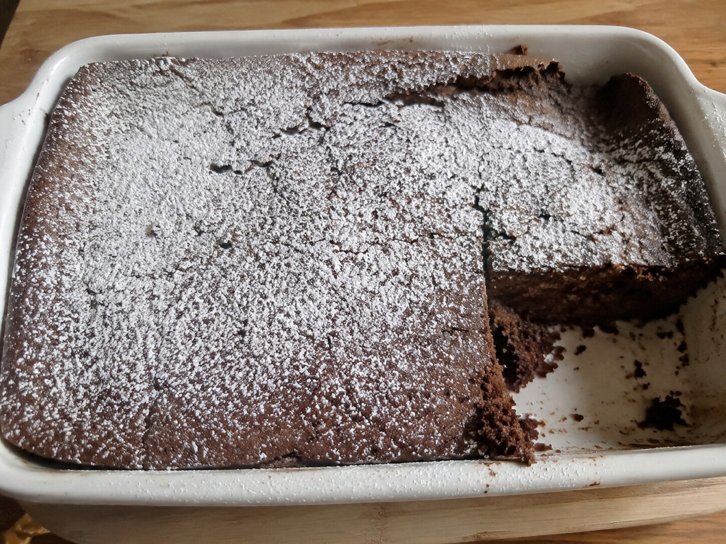 Homemade cocoa snack cake with a slice missing