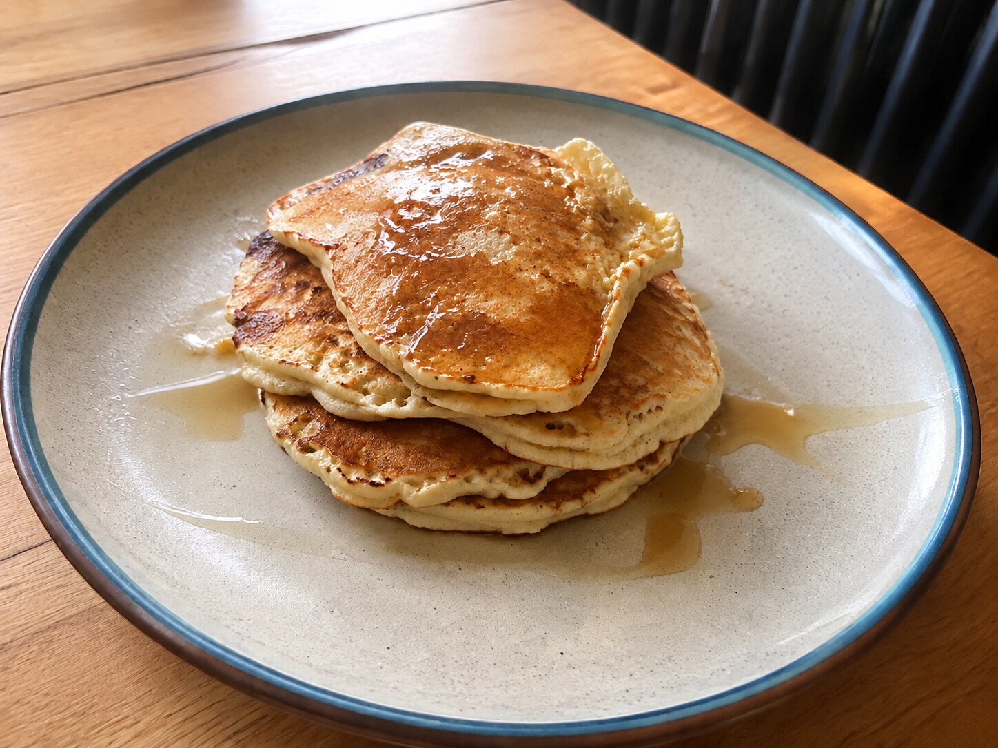 A slightly uneven stack of plain buttermilk pancakes