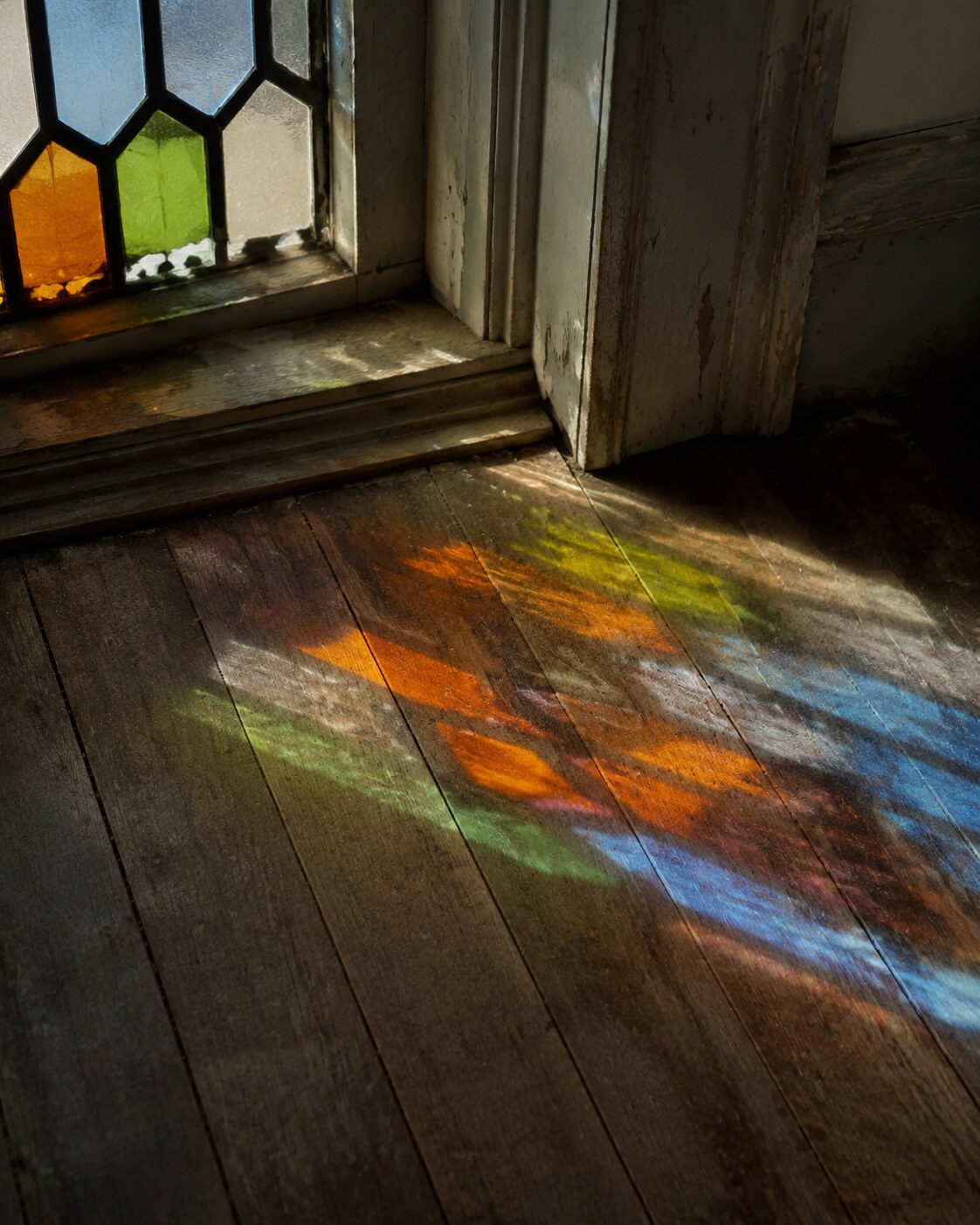 Colored light from a chipped stained-glass window