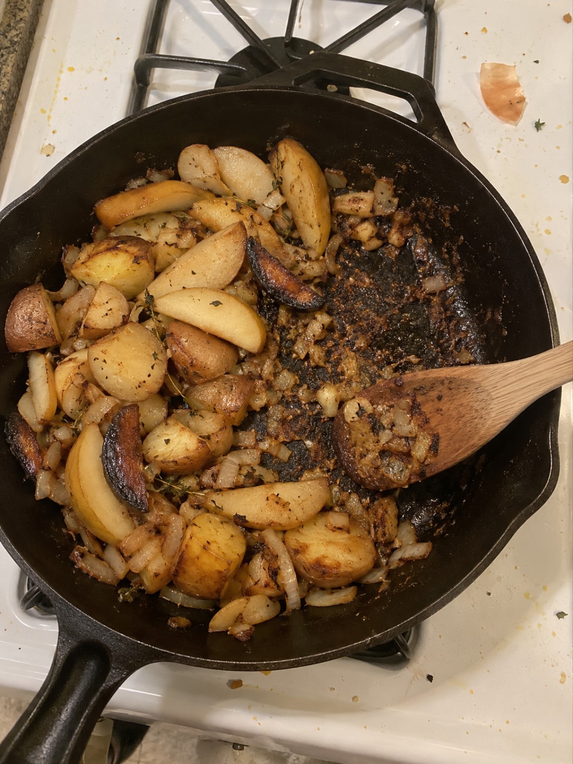 A skillet with one section of pear and onion browned too far